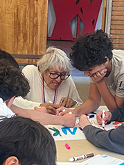 Students from Milken Community School teamed up with residents of the Newman Building to make signs in appreciation of the firefighters